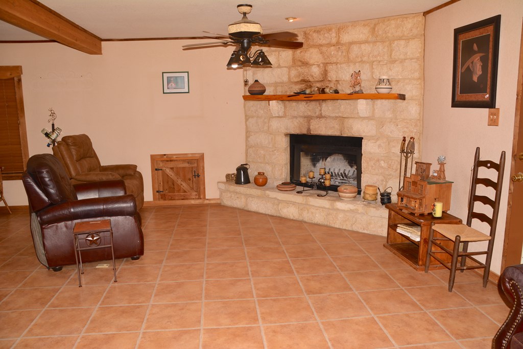 341 Seth Circle Bandera, TX 78003 - Photo 9 of 28 a living room with furniture and a fireplace