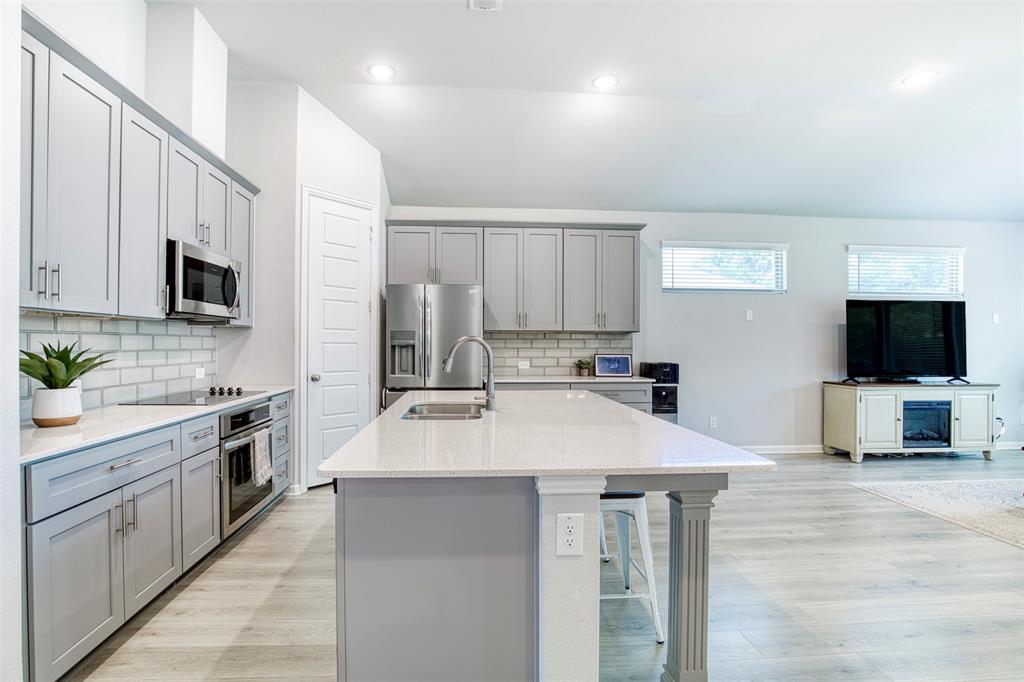 2012 Pacific Avenue Anna, TX 75409 - Photo 12 of 34 a large kitchen with kitchen island a sink and a stove top oven
