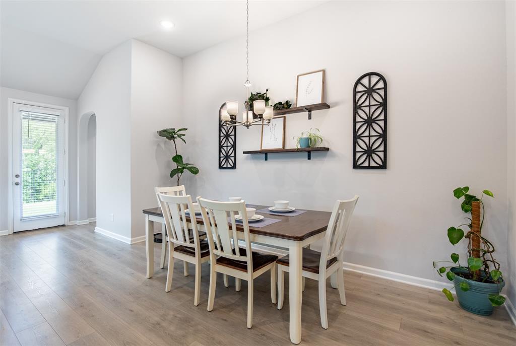 2012 Pacific Avenue Anna, TX 75409 - Photo 15 of 34 a view of a dining room with furniture and wooden floor