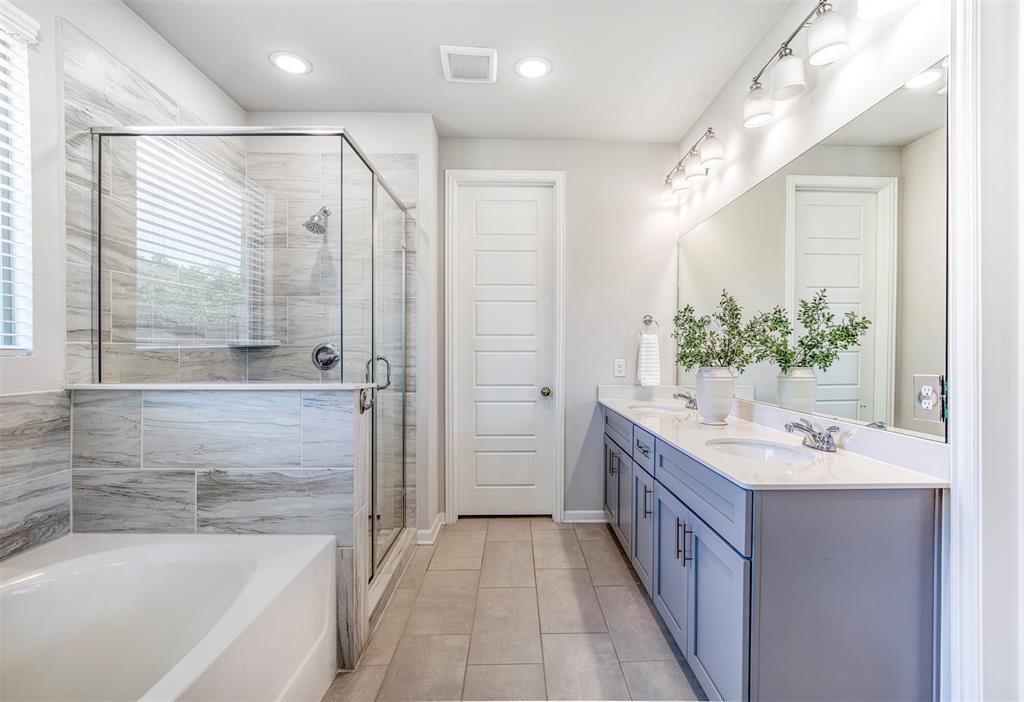 2012 Pacific Avenue Anna, TX 75409 - Photo 19 of 34 a bathroom with a double vanity sink and a bathtub