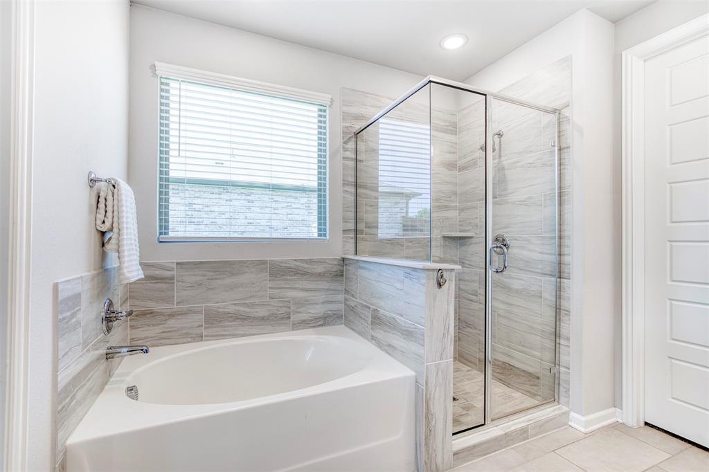 2012 Pacific Avenue Anna, TX 75409 - Photo 20 of 34 a bathroom with a bathtub and a shower