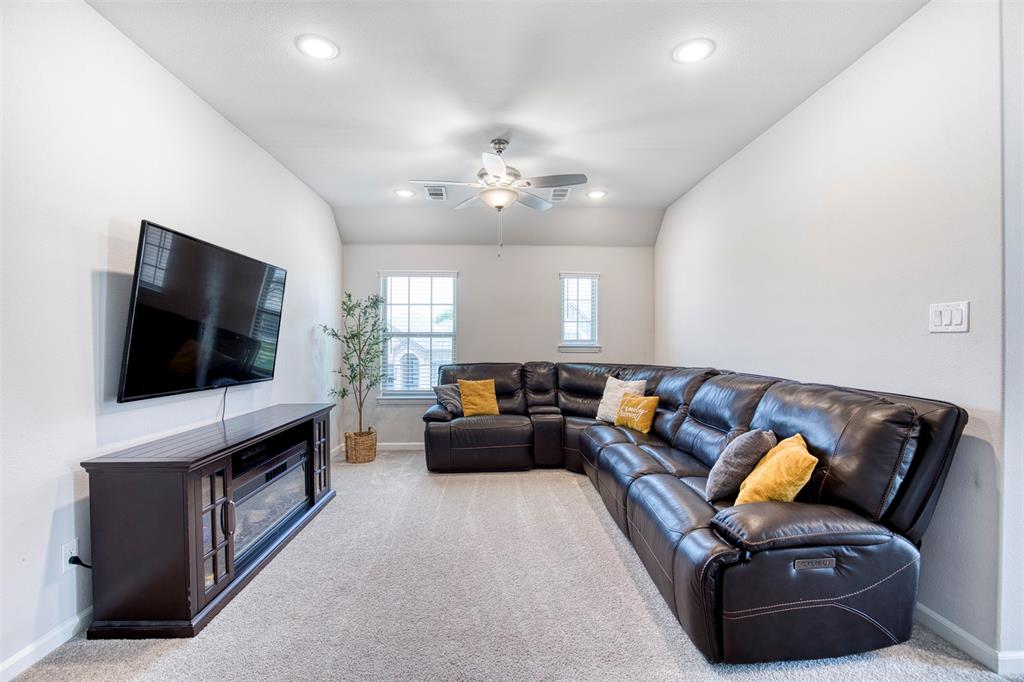 2012 Pacific Avenue Anna, TX 75409 - Photo 24 of 34 a living room with furniture and a flat screen tv