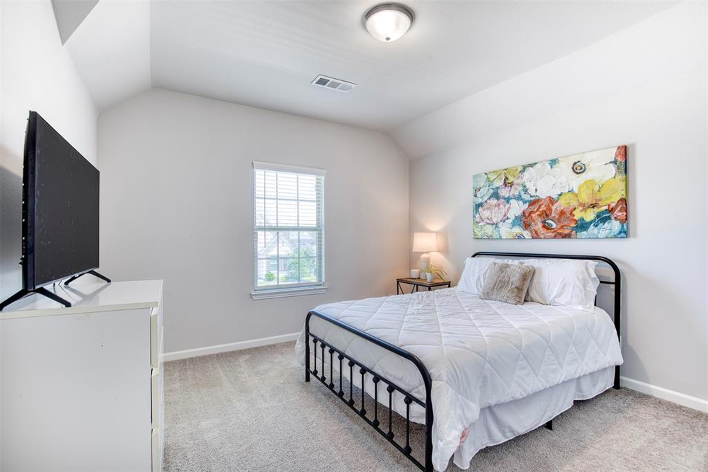 2012 Pacific Avenue Anna, TX 75409 - Photo 25 of 34 a bedroom with a bed and a flat screen tv