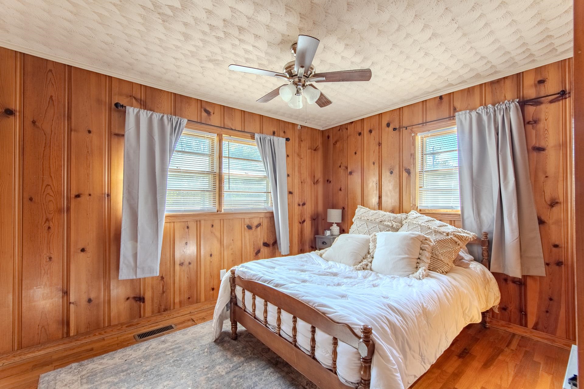 615 Patterson Road Savannah, TN 38372 - Photo 19 of 38 a bedroom with a large bed and a chandelier