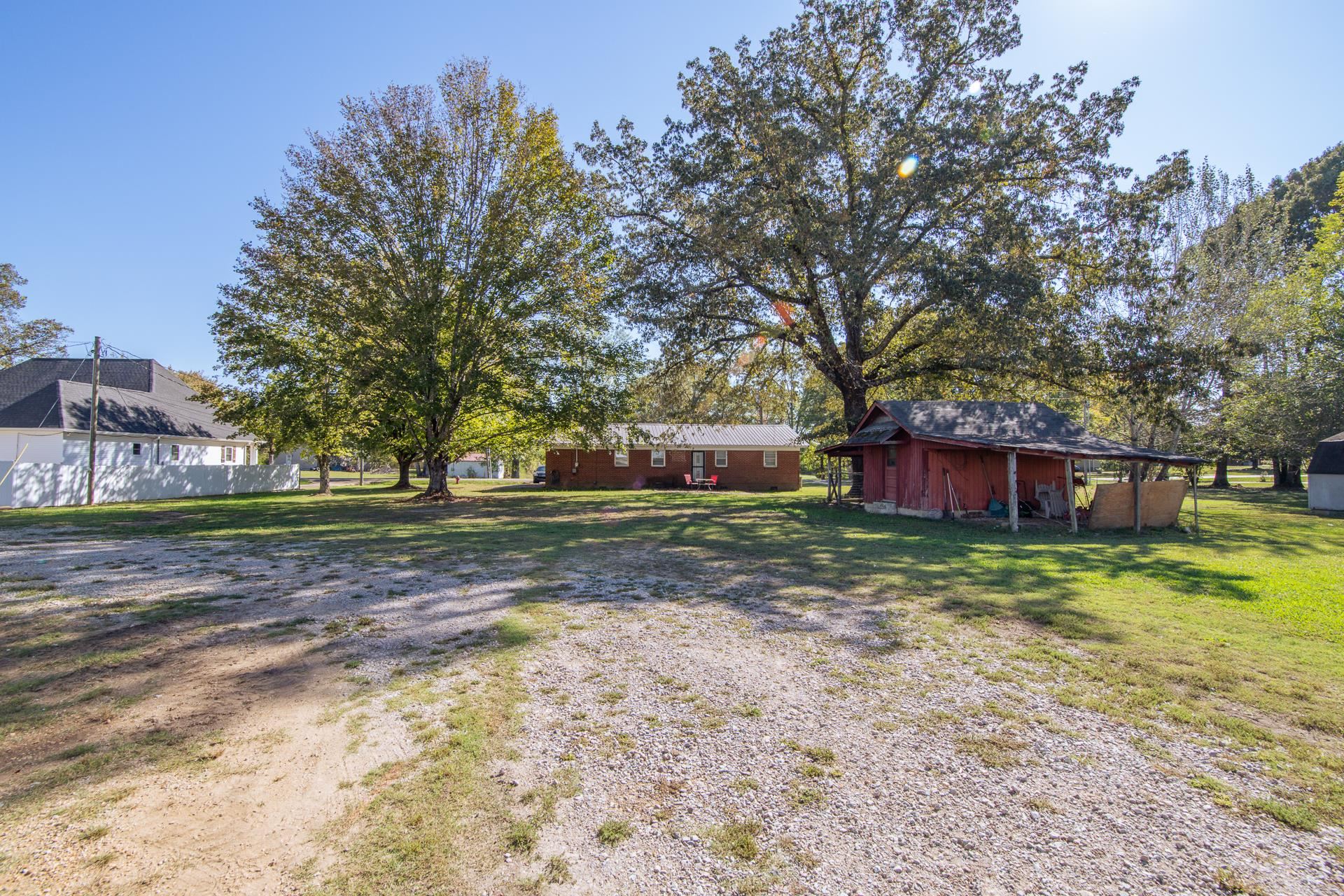 615 Patterson Road Savannah, TN 38372 - Photo 30 of 38 a view of a yard with a house and trees in the background