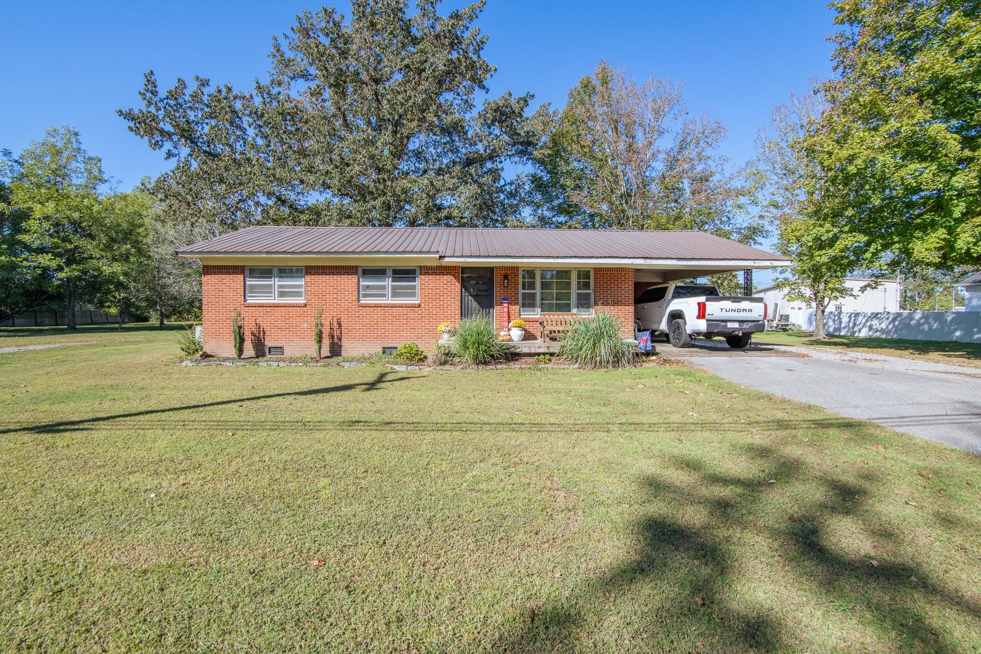 615 Patterson Road Savannah, TN 38372 - Photo 31 of 38 a front view of a house with a garden and trees