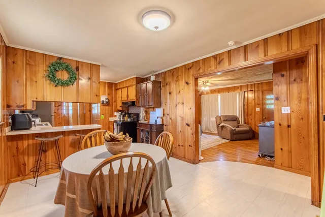 a dining room with furniture a window and kitchen view