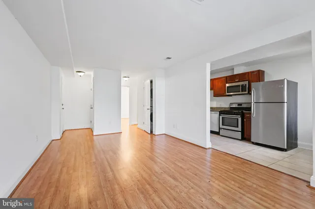 a view of kitchen view wooden floor and electronic appliances
