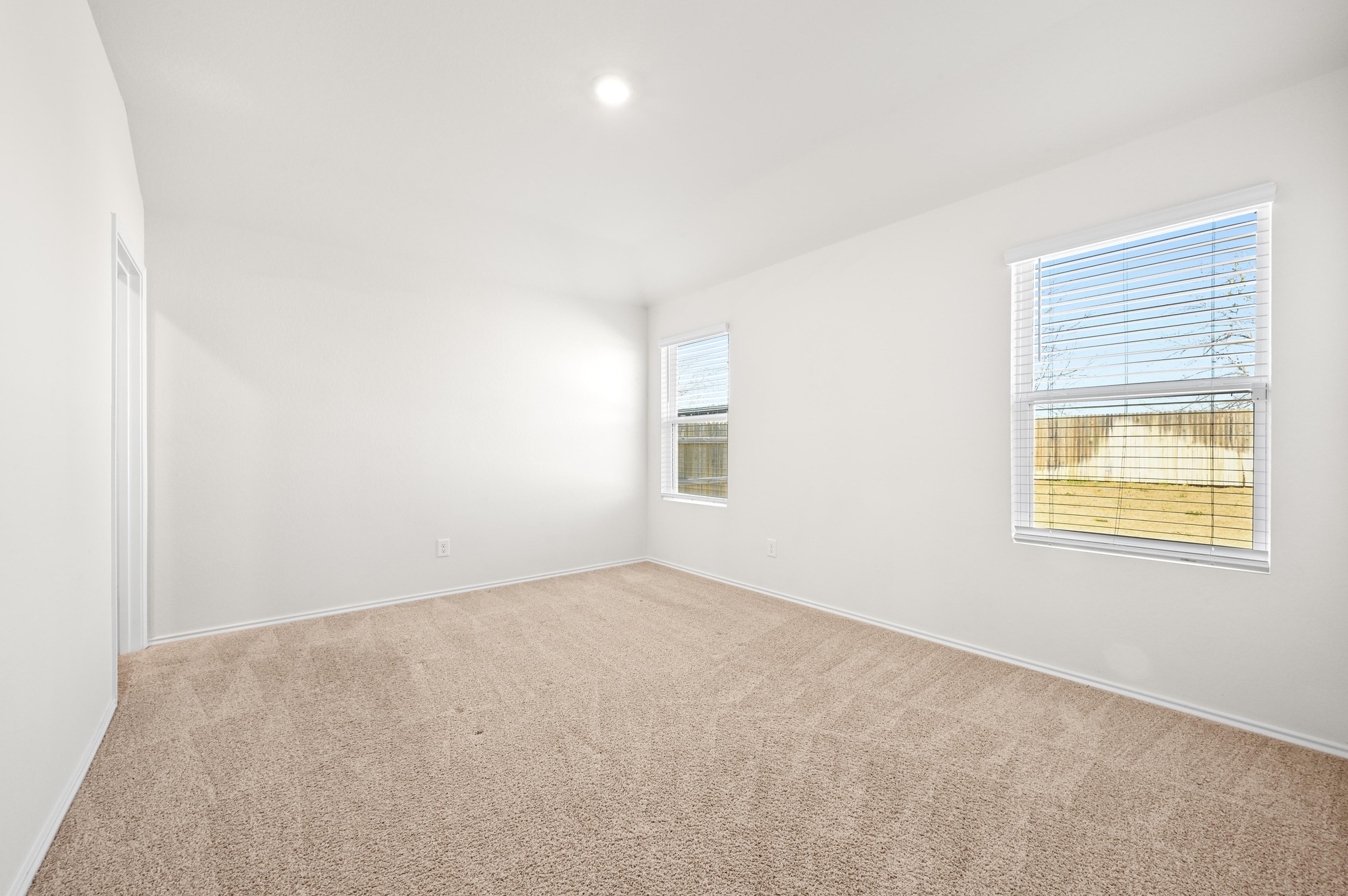 412 Sickle Loop Kyle, TX 78640 - Photo 13 of 25 Carpeted spare room featuring baseboards and recessed lighting