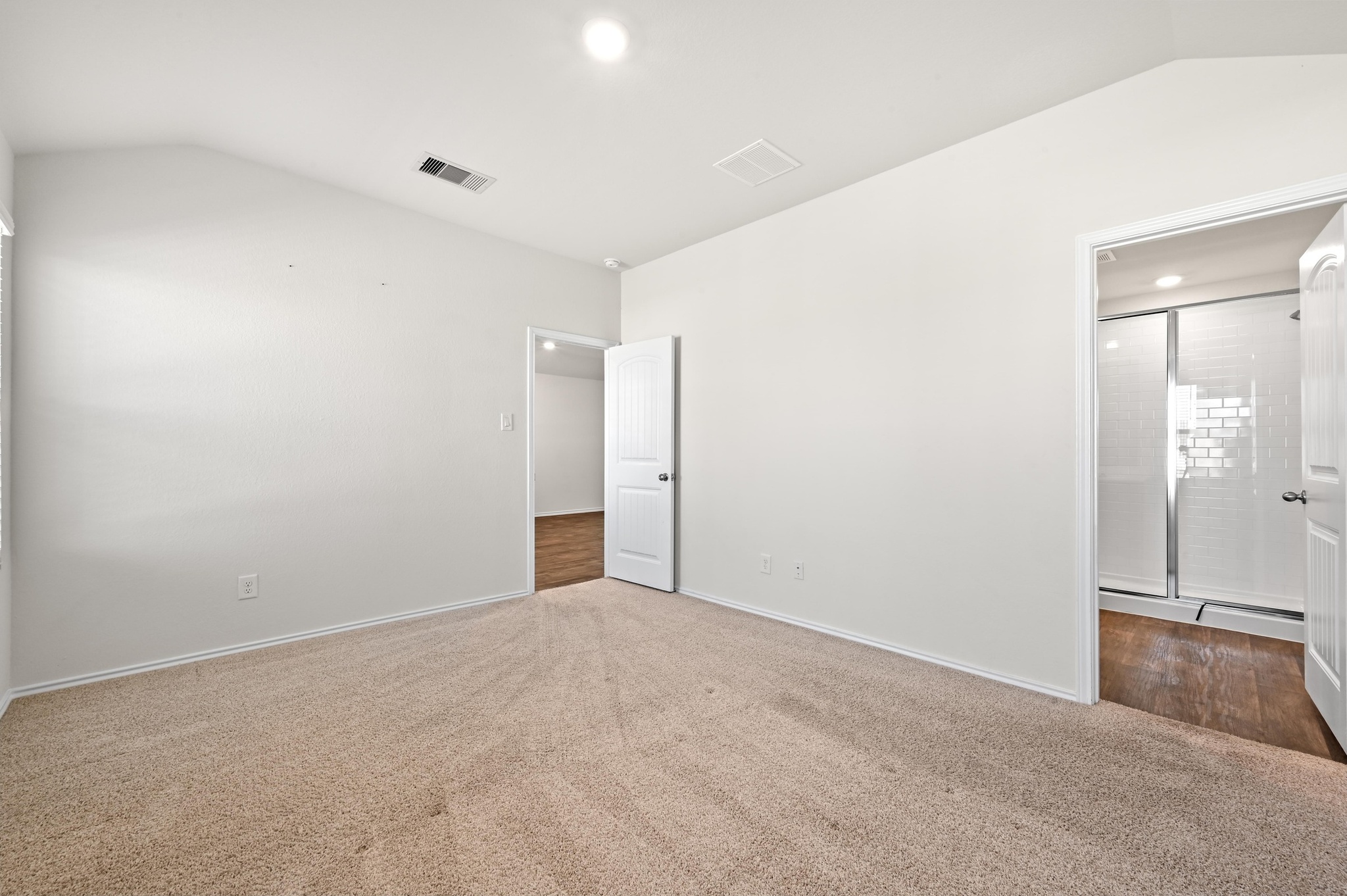 412 Sickle Loop Kyle, TX 78640 - Photo 14 of 25 Unfurnished bedroom with lofted ceiling and dark carpet