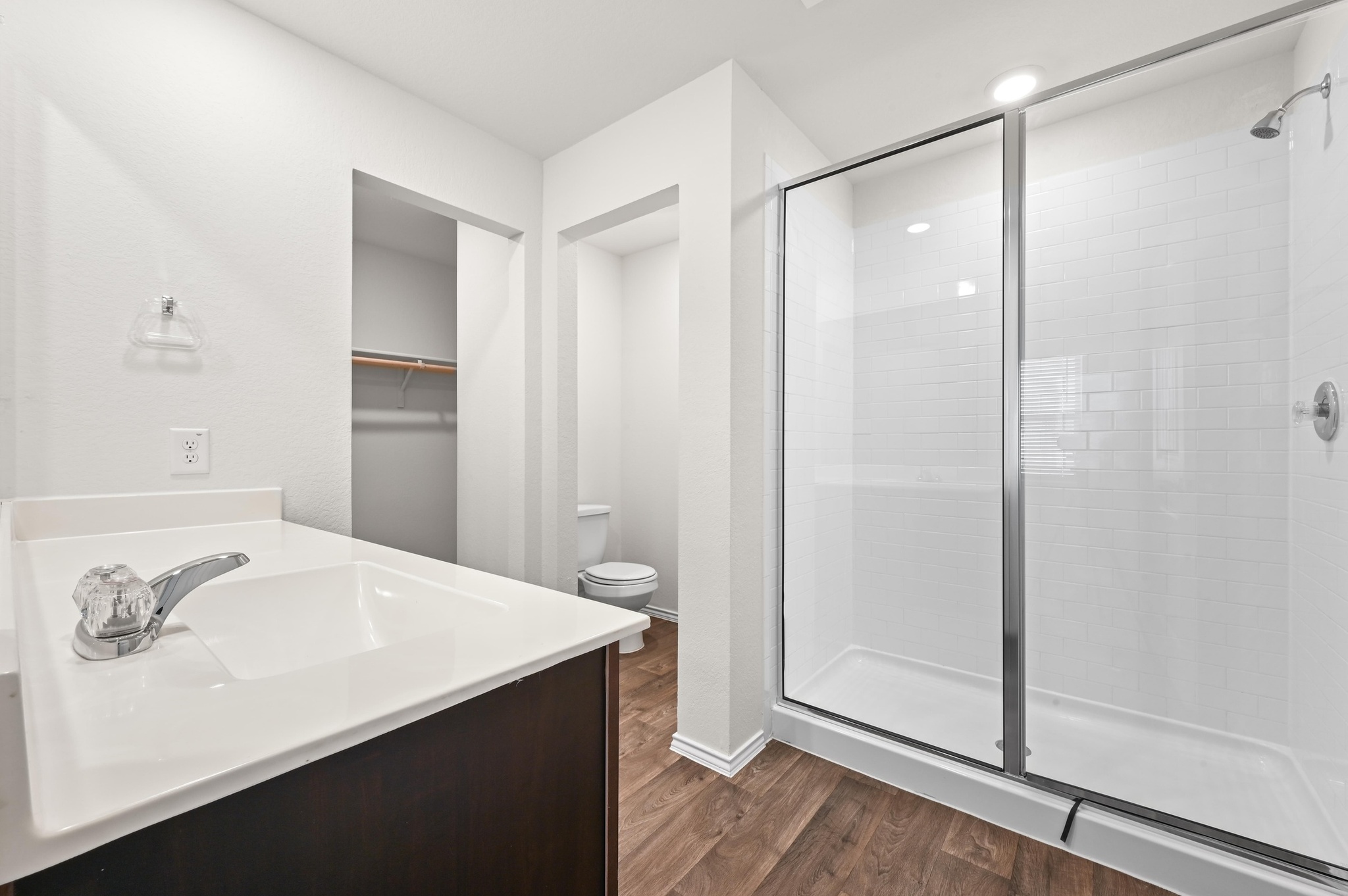 412 Sickle Loop Kyle, TX 78640 - Photo 15 of 25 Full bathroom with dark wood-style floors, vanity, a stall shower, and a spacious closet