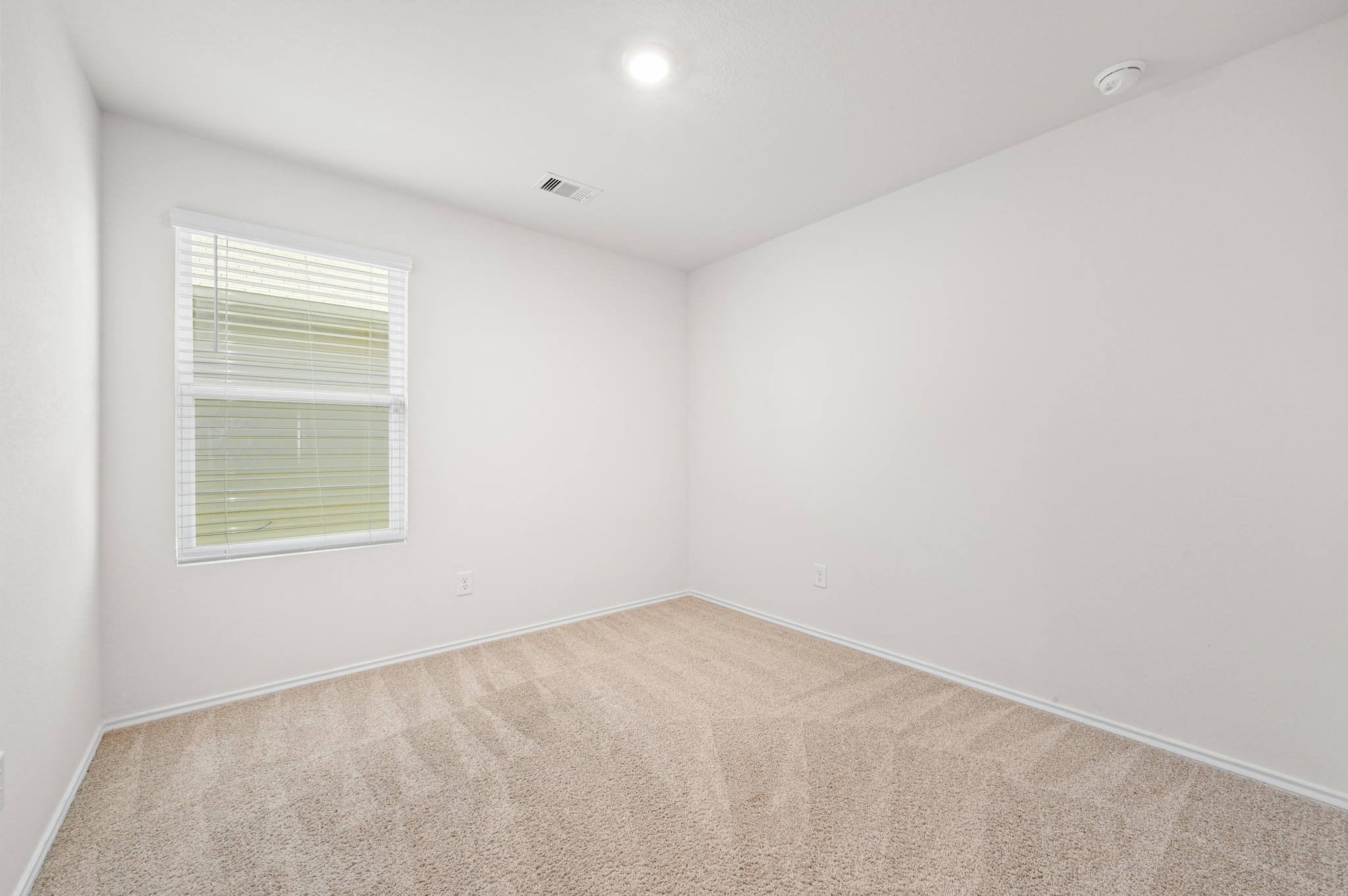 412 Sickle Loop Kyle, TX 78640 - Photo 18 of 25 Spare room with light carpet and baseboards