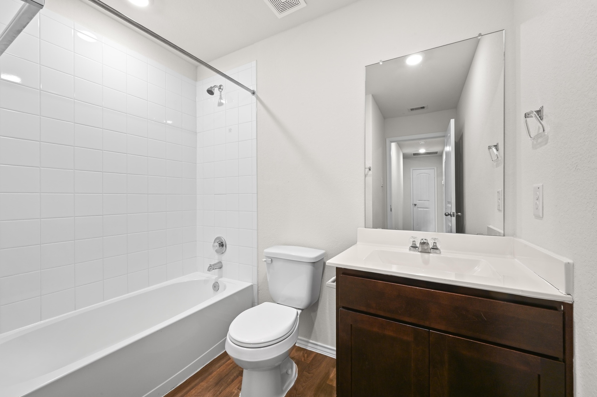 412 Sickle Loop Kyle, TX 78640 - Photo 20 of 25 Full bath featuring vanity, dark wood-type flooring, bathing tub / shower combination, and recessed lighting