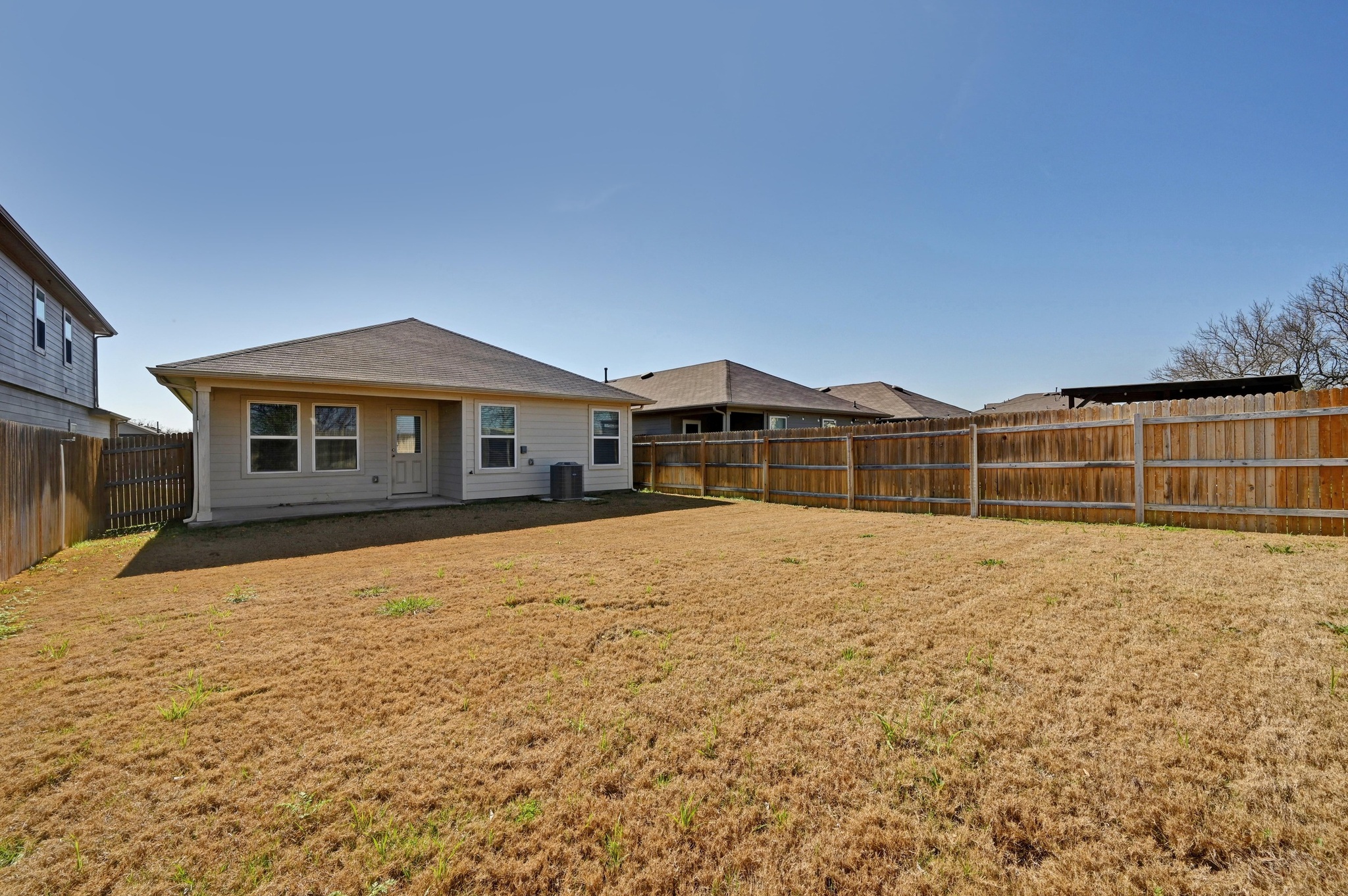 412 Sickle Loop Kyle, TX 78640 - Photo 24 of 25 Rear view of house featuring a fenced backyard and a patio