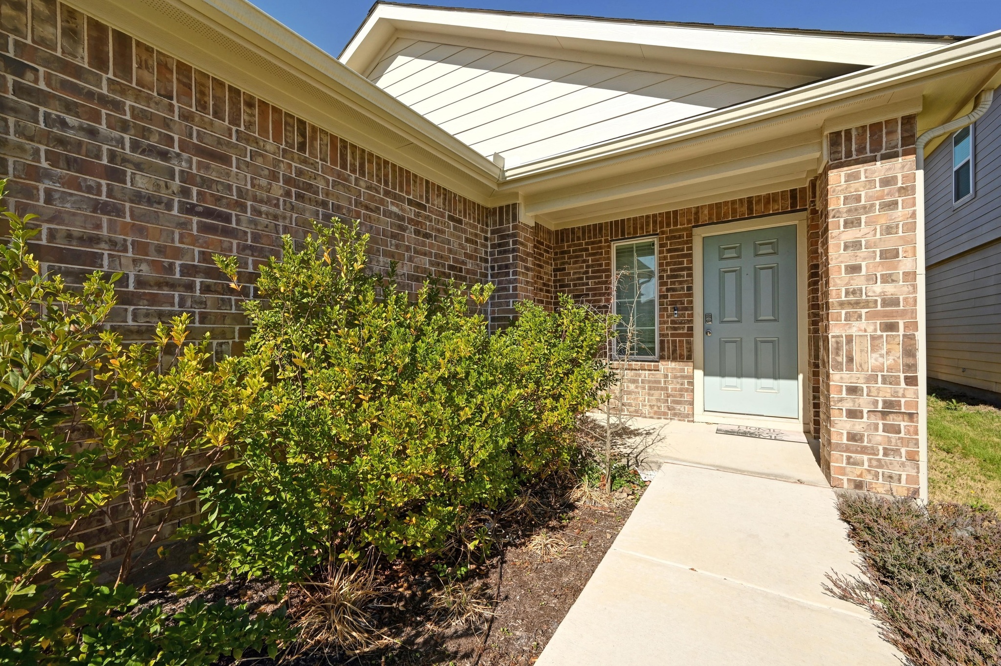 412 Sickle Loop Kyle, TX 78640 - Photo 4 of 25 Property entrance featuring brick siding and a porch