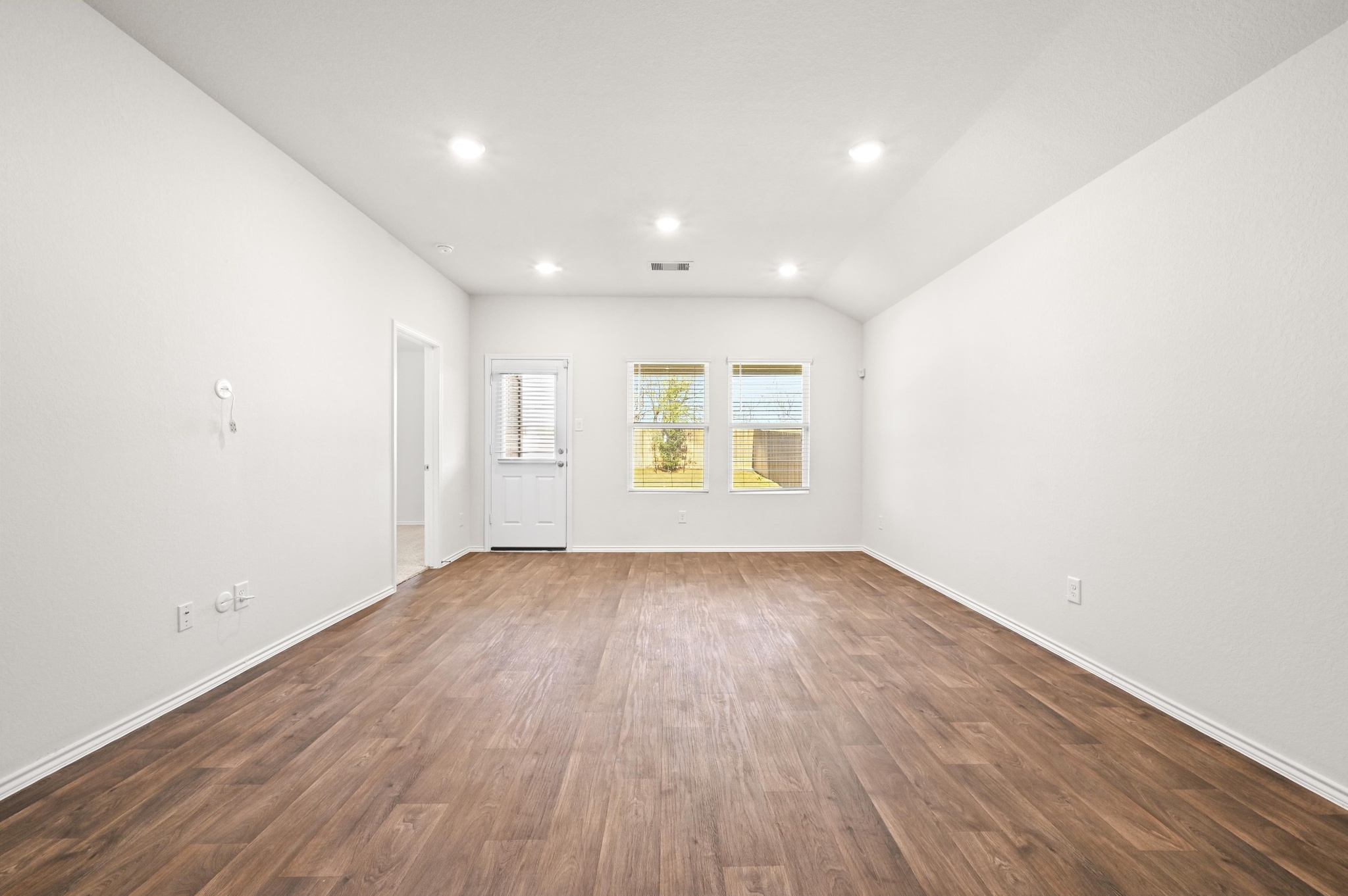 412 Sickle Loop Kyle, TX 78640 - Photo 9 of 25 Spare room featuring dark wood finished floors, vaulted ceiling, and recessed lighting