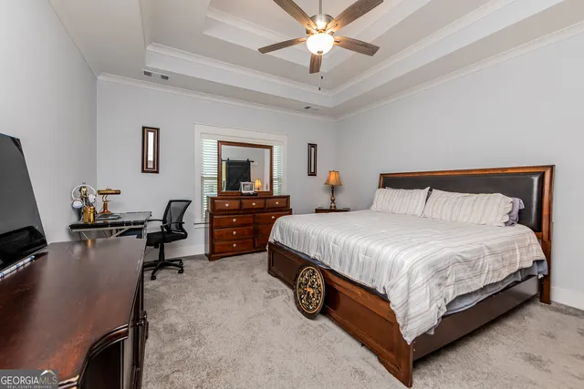 a bedroom with a bed gym equipment and a chandelier
