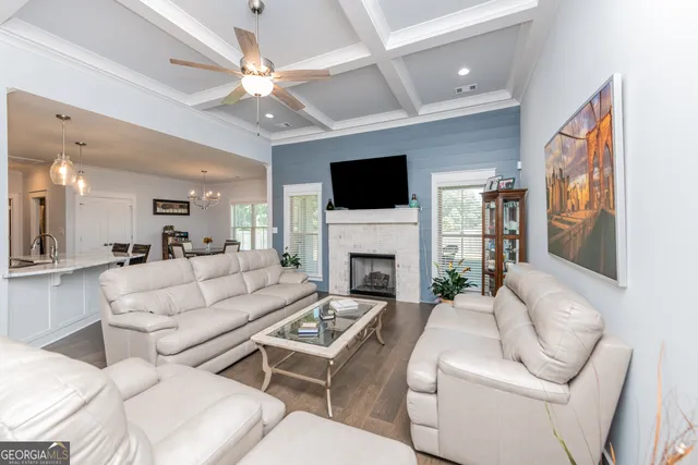 a living room with furniture a fireplace and a flat screen tv