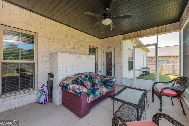 a bedroom with furniture and a large window