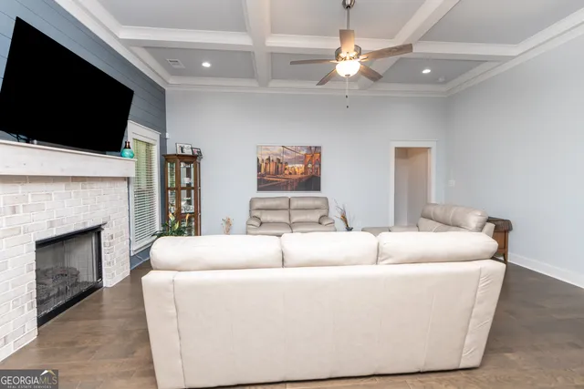 a living room with a couch a flat screen tv and a fireplace