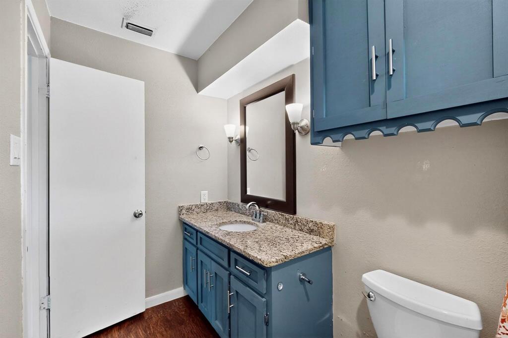 4857 Fallon Place Dallas, TX 75227 - Photo 17 of 19 Half bath with vanity and dark wood-style floors