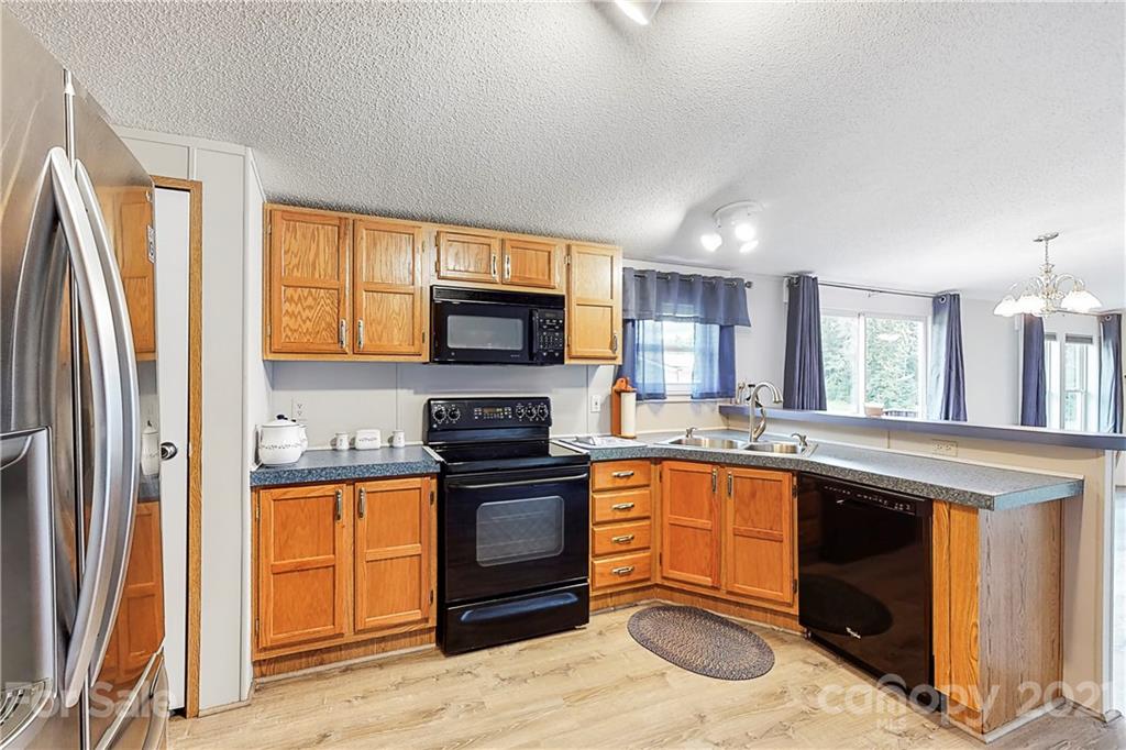 2688 Howells Ferry Road Hickory Grove, SC 29717 - Photo 13 of 43 a kitchen with stainless steel appliances granite countertop a stove a sink and a microwave
