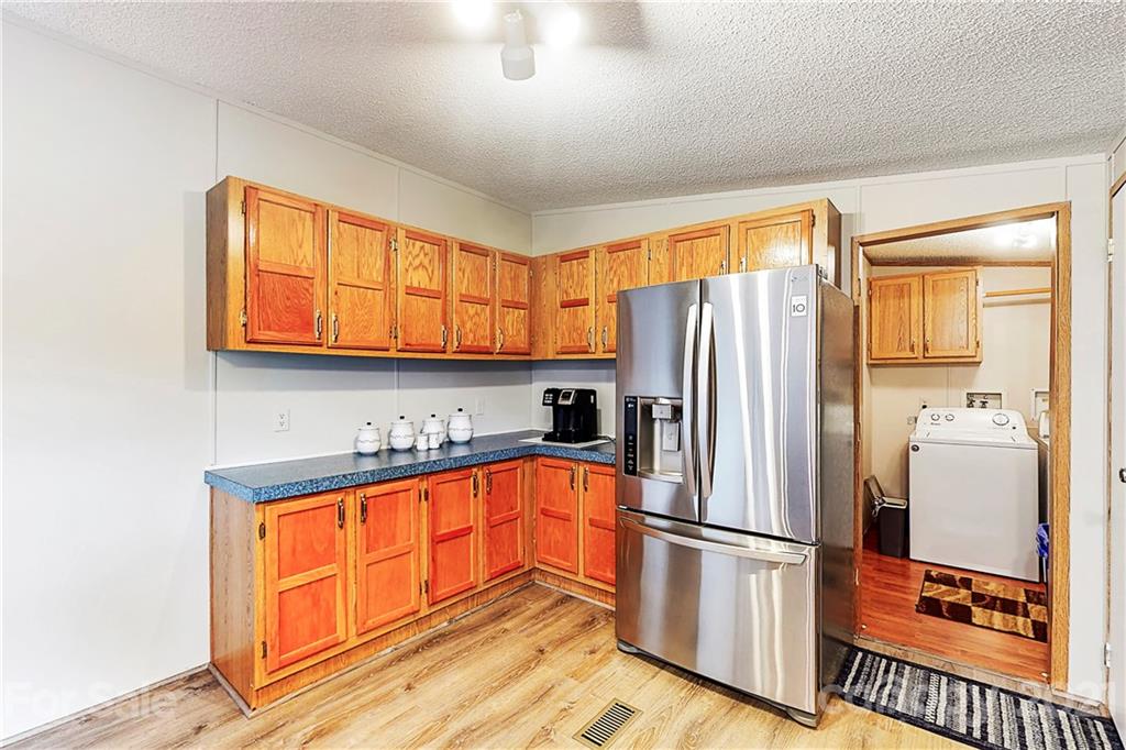 2688 Howells Ferry Road Hickory Grove, SC 29717 - Photo 14 of 43 a kitchen with stainless steel appliances granite countertop a refrigerator a sink and a stove with wooden floors