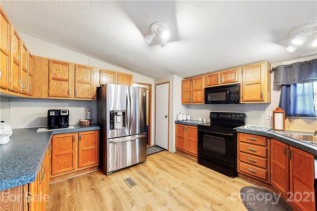 2688 Howells Ferry Road Hickory Grove, SC 29717 - Photo 15 of 43 a kitchen with stainless steel appliances granite countertop a refrigerator stove top oven a sink and dishwasher