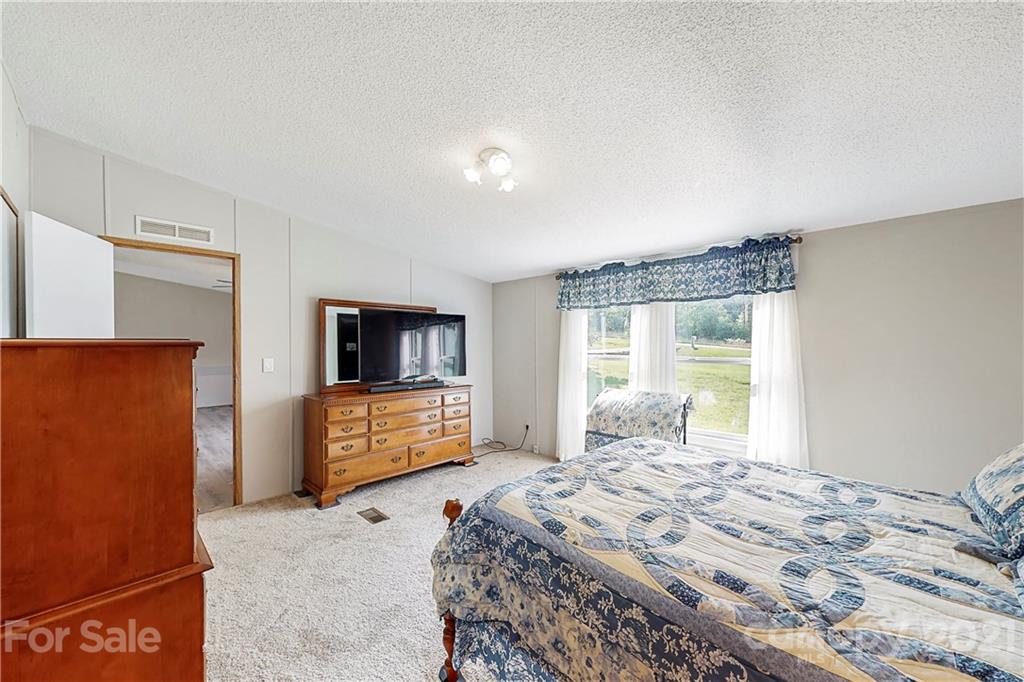 2688 Howells Ferry Road Hickory Grove, SC 29717 - Photo 17 of 43 a bedroom with a bed and a dresser