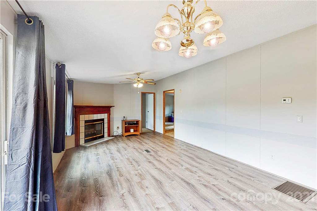 2688 Howells Ferry Road Hickory Grove, SC 29717 - Photo 3 of 43 a view of an empty room with a fireplace and a window