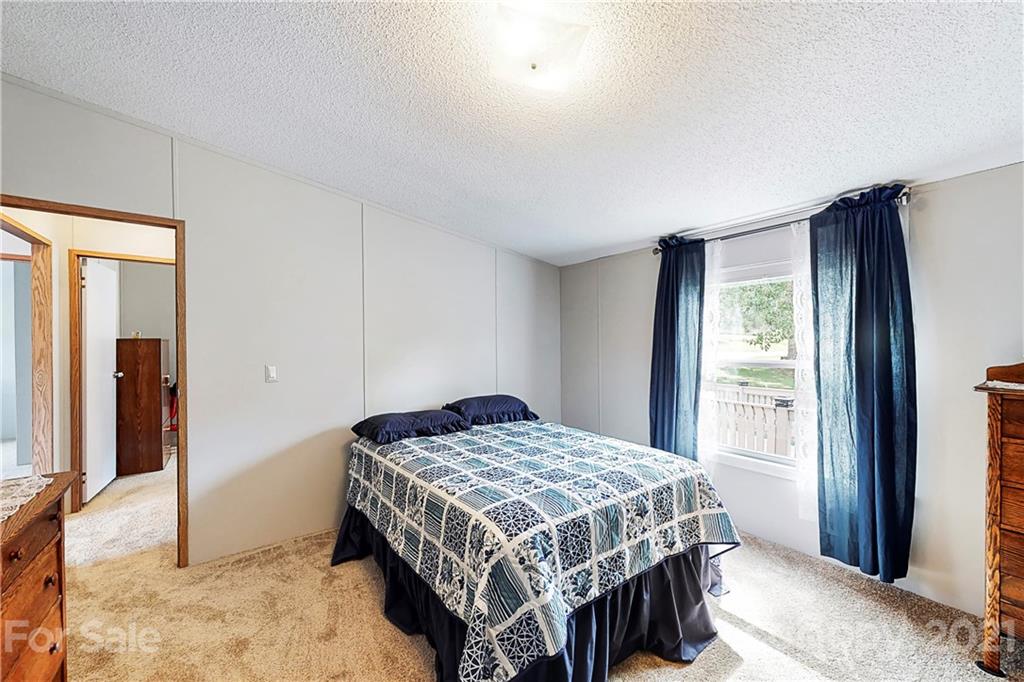 2688 Howells Ferry Road Hickory Grove, SC 29717 - Photo 24 of 43 a bedroom with a bed and a dresser next to a window