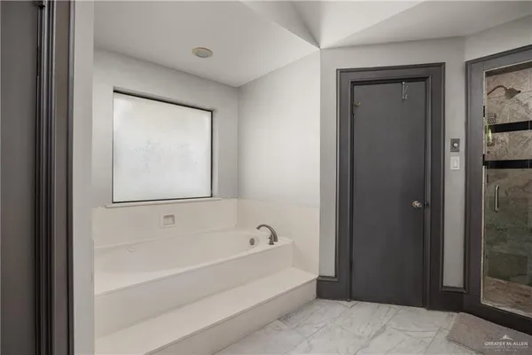 a bathroom with a bathtub and a shower