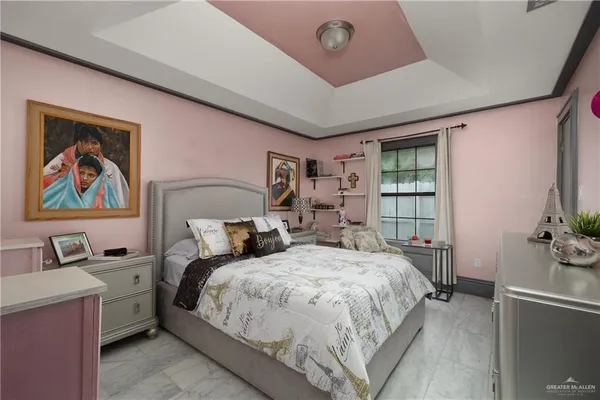 a bedroom with a bed and a potted plant