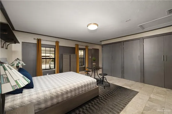 a bedroom with a large bed and a large window