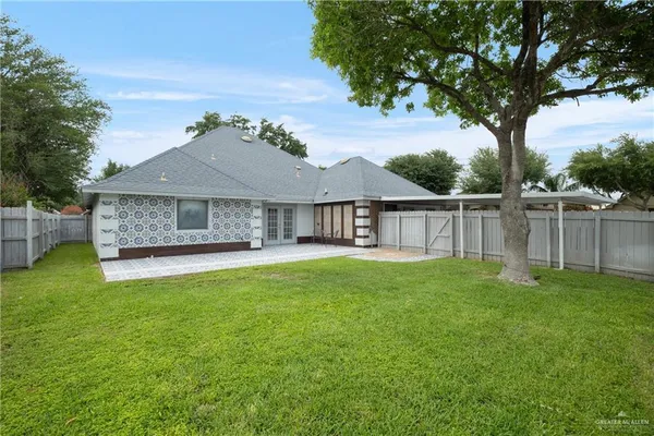 a view of a house with a backyard and a patio