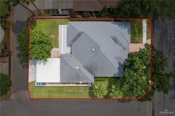 an aerial view of a house with a yard and a fountain