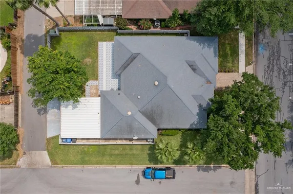 an aerial view of a house with a yard and a fountain