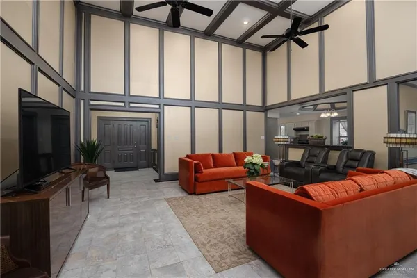 a living room with furniture a flat screen tv and a window