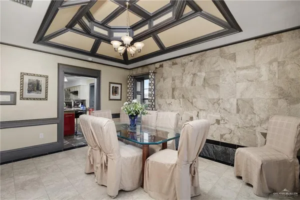 a view of a dining room with furniture and a chandelier