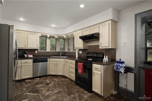 a kitchen with a sink stove and microwave