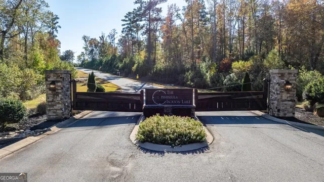 a view of a house with large windows and a tree