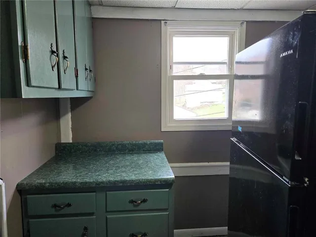 a kitchen with a granite countertop sink and a window