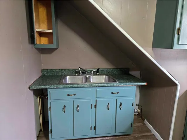 a kitchen with a cabinets and chandelier
