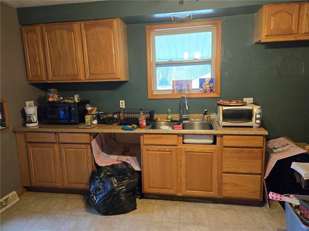 104 Forrest Street Petrolia, PA 16050 - Photo 5 of 22 a kitchen with stainless steel appliances granite countertop a stove a sink and a microwave