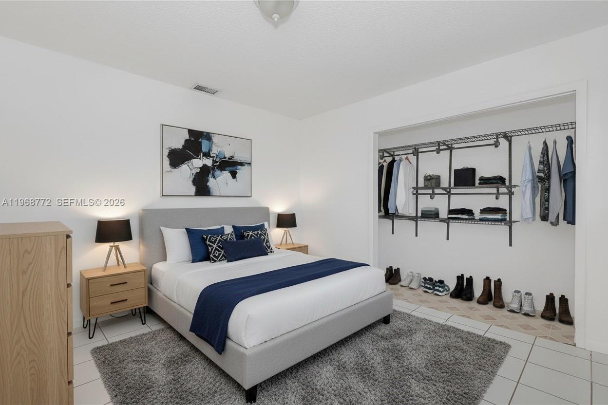 1082 West 79th Street, Unit 25 Hialeah, FL 33014 - Photo 11 of 16 a bedroom with a bed a mirror and night stand