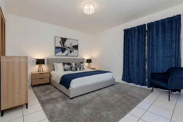 a bedroom with a bed and a chair