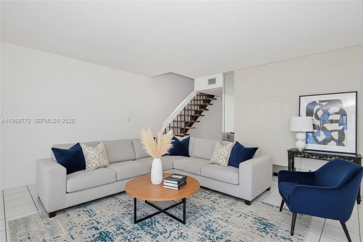1082 West 79th Street, Unit 25 Hialeah, FL 33014 - Photo 4 of 16 a living room with furniture and a potted plant