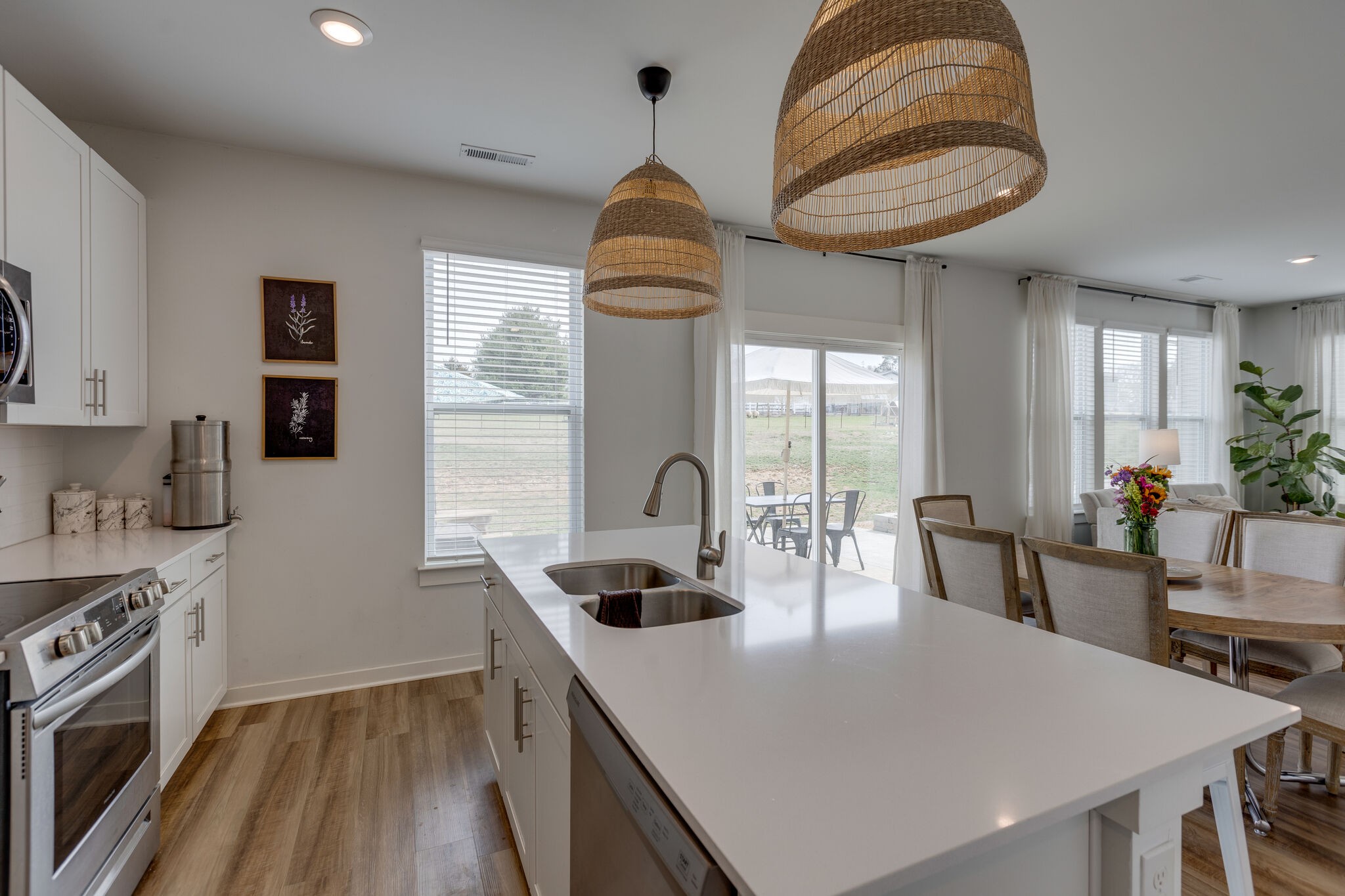 409 Irwin Way Spring Hill, TN 37174 - Photo 16 of 32 a kitchen with stainless steel appliances a dining table chairs stove and white cabinets