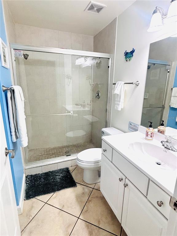 19417 Gulf Boulevard, Unit B209 Indian Rocks Beach, FL 33785 - Photo 13 of 24 a bathroom with a granite countertop sink toilet and shower