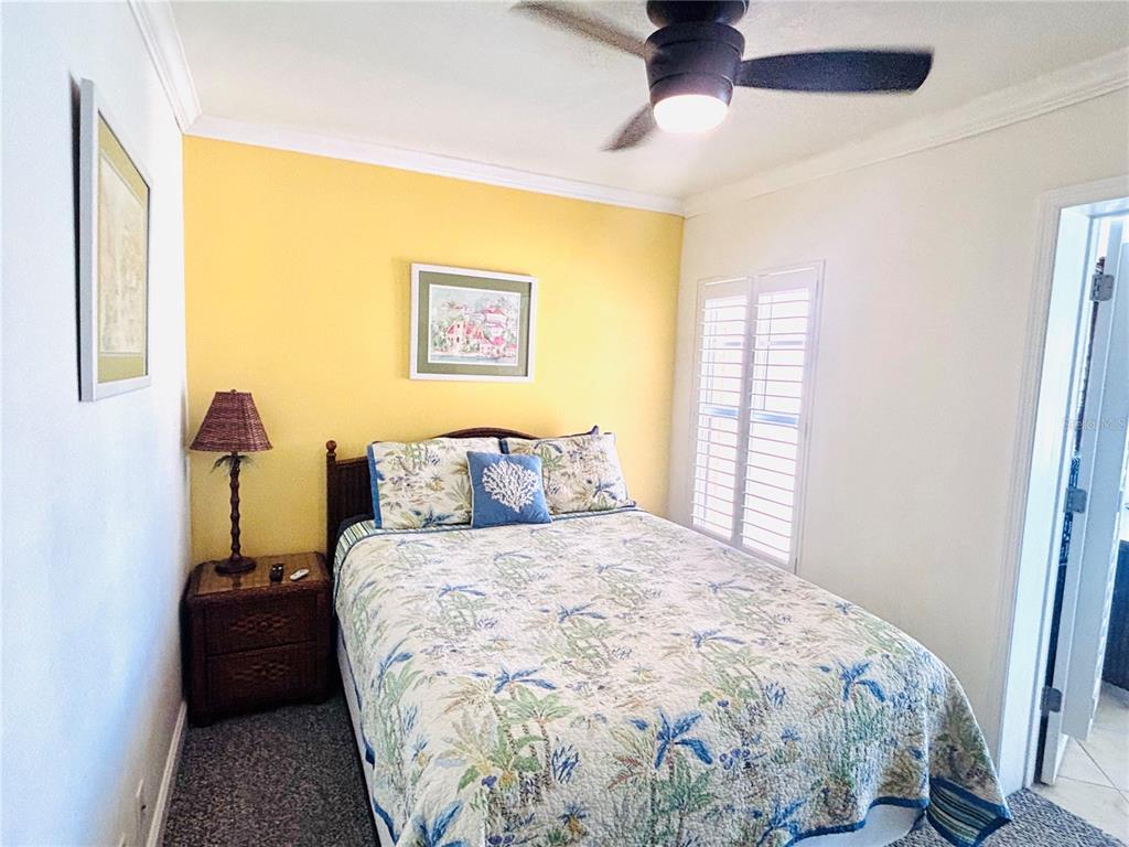 19417 Gulf Boulevard, Unit B209 Indian Rocks Beach, FL 33785 - Photo 14 of 24 a bedroom with a bed and a window